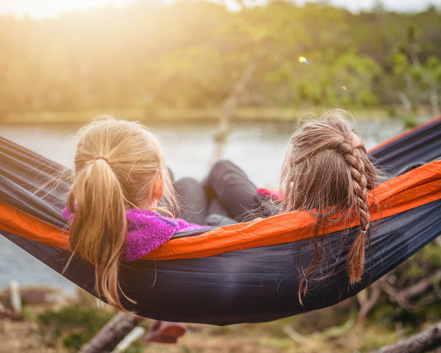 Two kids sitting hammock 