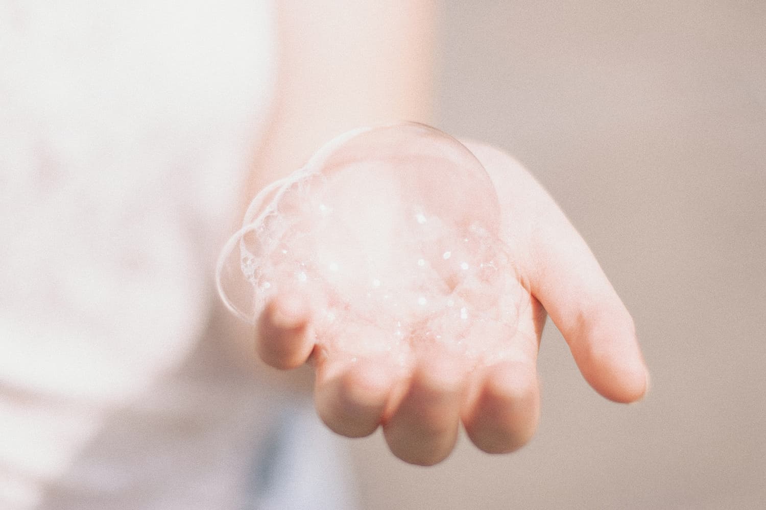 Hand with soap bubbles in it