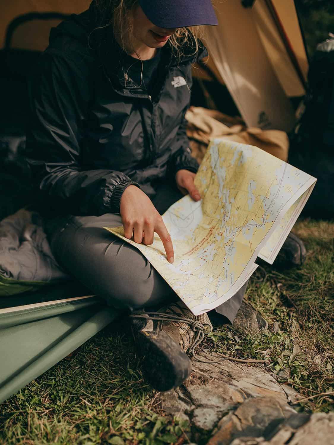 Person in stylish jacket looking at map